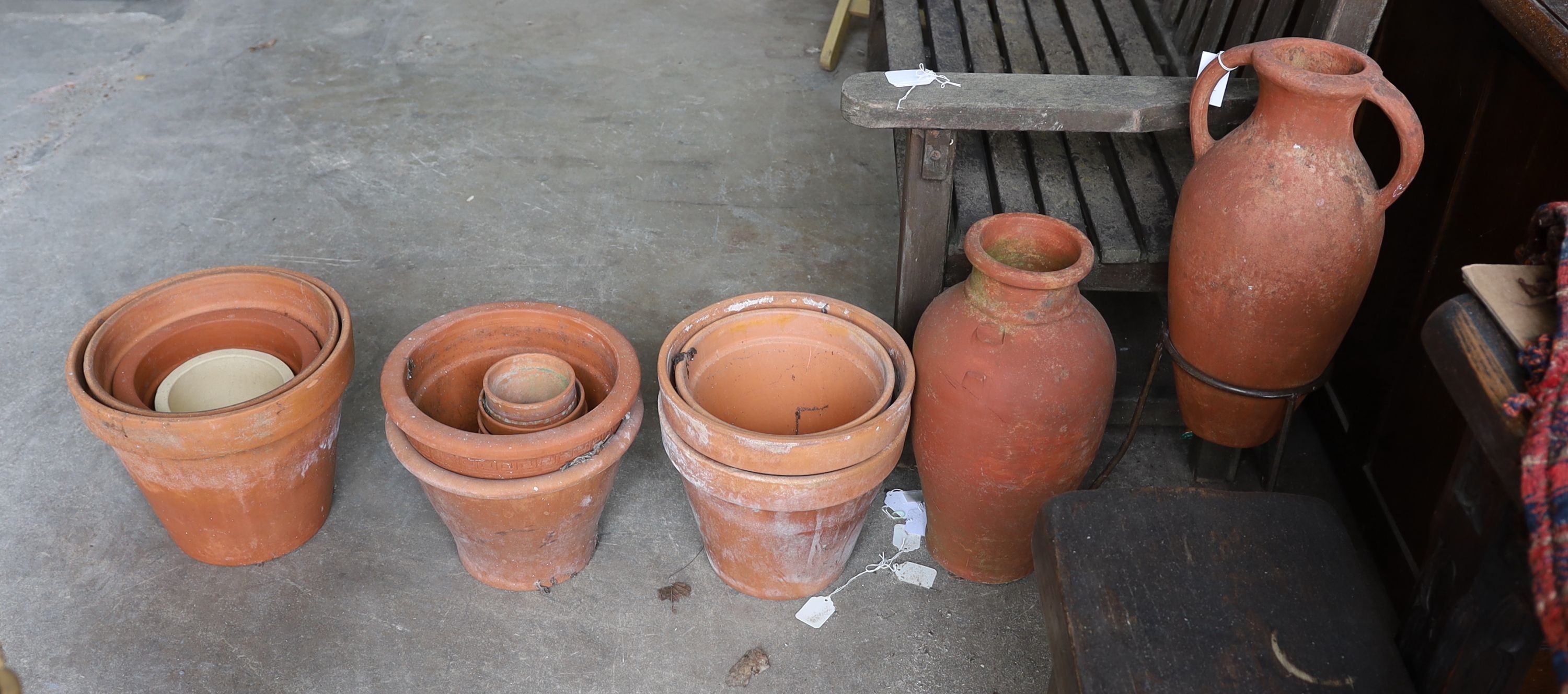Two Greek style terracotta garden urns, one with iron stand, together with twelve assorted terracotta garden planters